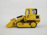a toy bulldozer that is sitting on a white surface
