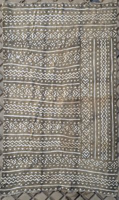a white and black rug with a pattern on it
