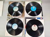 three black vinyl records sitting on top of each other on a table