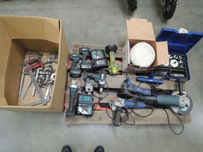 a box full of tools on the floor next to a pair of shoes