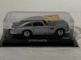 a silver car in a glass case on a white surface