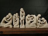 a sculpture of a group of people sitting on a table