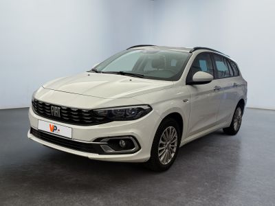 the white car is parked in a large room with a black floor