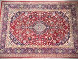 a red rug with a medallion design on it