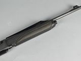 a close up of a gun on a table with a white background