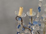 a close up of a chandelier with blue and white beads