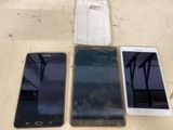 three samsung phones are sitting next to each other on a table