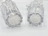 a pair of earrings that are made out of clear plastic