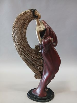 statue of a woman with a bird on her head on a base