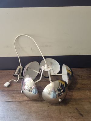 a pair of silver shoes that are on a wooden floor