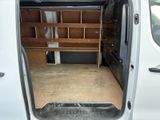 a white van that has a small desk in the back