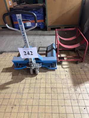 a small cart with a sign on it in the middle of the floor