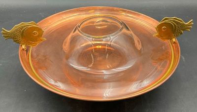 a glass bowl with a gold fish decoration on it