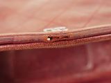 close up of a brown leather purse with a metal clasp