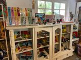 a white cabinet with a lot of toys on top of it