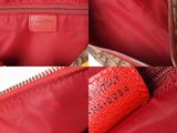 a close up of a red purse with a tag on it