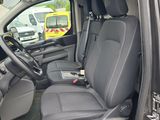 the interior of a car with the door open and the driver ' s seat down