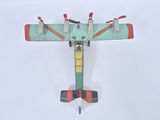 a small toy airplane that is flying in the sky