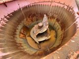 an old rusted water fountain with a rusty spout