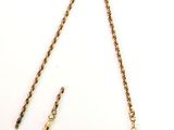 an image of a gold necklace with a chain attached to it