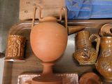 many different vases on a table with a cutting board