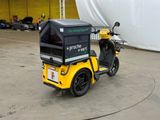 a small yellow motorcycle with a black box on the back