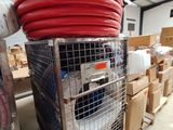 a metal cart with a bunch of red hoses on top of it