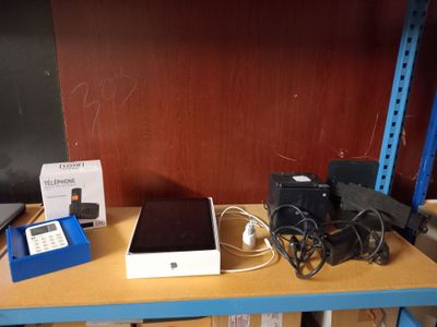 several electronic devices are sitting on a shelf in a room