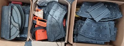a cardboard box filled with blue jeans and a pair of orange shoes