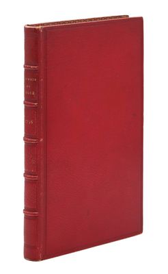 un livre rouge à la couverture rouge posé sur une surface blanche