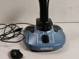 a game controller sitting on a table next to a mouse