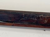 a very old gun that is on display on the table