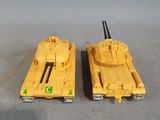 two yellow toy tanks sitting side by side on a table