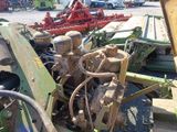 a tractor that is parked in a lot with other tractors