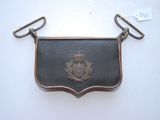 un petit porte-monnaie en métal orné d'un emblème en métal