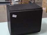 a black box sitting on top of a table in a warehouse