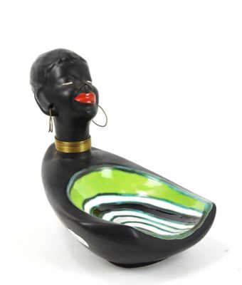 a black duck with a green body and a red lip