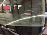 a reflection of a man in the back seat of a truck