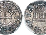 a close up of a coin with a cross on it