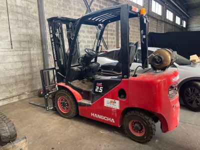 a red forklift truck parked in a garage
