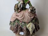 a figurine of a woman sitting on a table