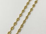 a close up of a gold chain on a white surface