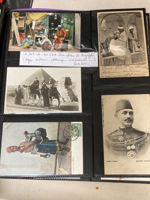 several old photos of men and women are displayed on a table