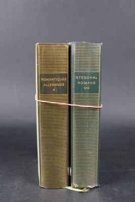 a pair of books sitting on top of each other on a table