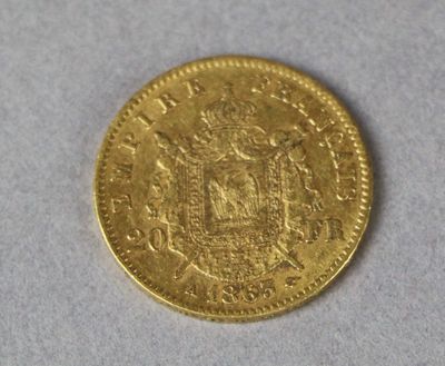a close up of a gold coin on a white surface