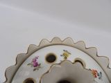 a white vase with a flower design on it