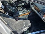 the interior of a car with the door open and the driver ' s seat down