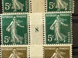 four different stamps with a woman on them on a black surface