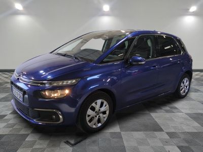 a blue citrole parked on a checkered floor in a garage