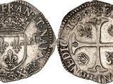 a silver coin with a crown on the front and a shield on the back